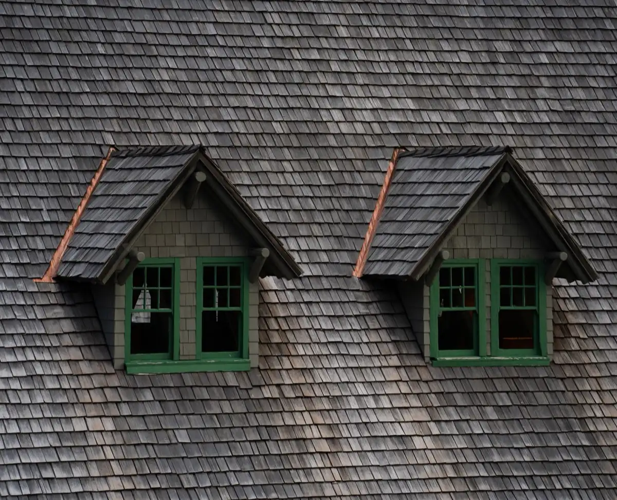 Dormers on a shingle roof in Tyler, TX, where step flashing and kickout flashing carry water past the walls
