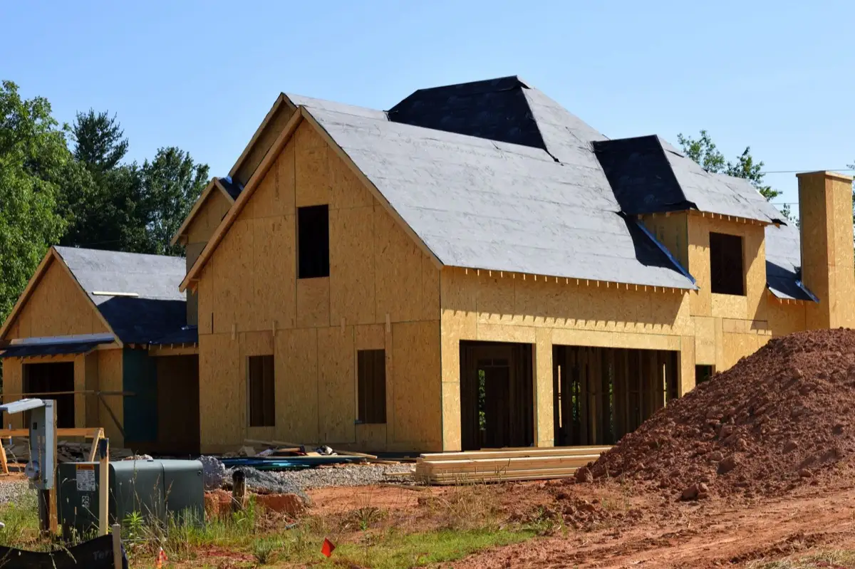 Underlayment rolled and capped on a bare roof deck in Tyler, TX